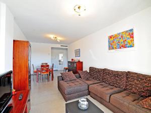 a living room with a couch and a table at Apartment Isleta Marina-3 by Interhome in Jávea