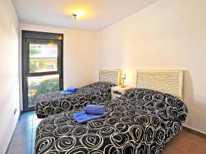 a bedroom with two beds and a window at Apartment Isleta Marina-3 by Interhome in Jávea +15 photos