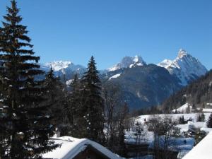 a view of a snowy mountain range with snow covered mountains at Apartment Monique Nr- 1 by Interhome in Gstaad