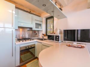 a kitchen with a white counter top and a table at Apartment Paola by Interhome in Cannigione