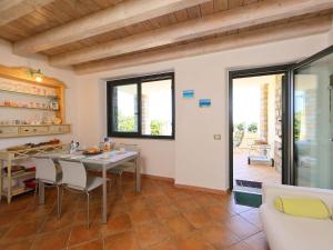 a kitchen and dining room with a table and chairs at Apartment Paola by Interhome in Cannigione