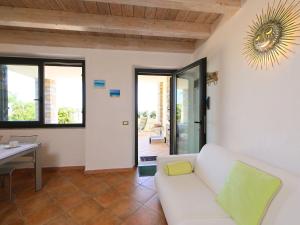 a living room with a white couch and a table at Apartment Paola by Interhome in Cannigione +24 photos