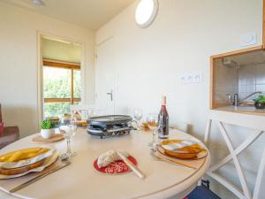a kitchen with a table with glasses of wine at Apartment Soyouz Vanguard-87 by Interhome in Le Corbier +30 photos