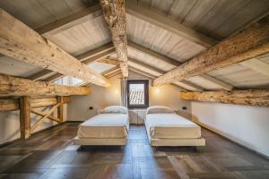 a room with three beds and wooden ceilings at Corte Rubbi 11 Secret Terrace Apartment in Venice