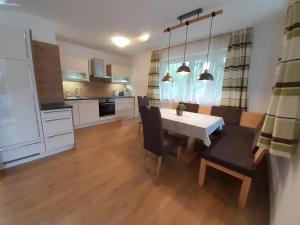 a kitchen and dining room with a table and chairs at Apart Lisa in Mayrhofen