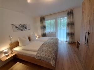 a bedroom with a bed and a large window at Apart Lisa in Mayrhofen