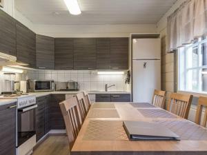 a kitchen with a table with a laptop on it at Holiday Home Levin kultakoto by Interhome in Sirkka