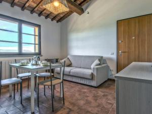 uma sala de estar com um sofá e uma mesa em Apartment Poggio di Nocola-1 by Interhome em Riparbella