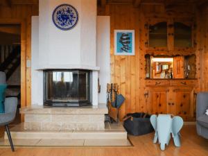 a living room with a fireplace in a house at Chalet Chalet Les Rochers Blancs by Interhome in Chesières +37 photos