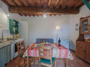 a kitchen with a table and chairs in a room at Holiday Home San Remigio by Interhome in Montignoso