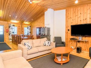 a living room with a couch and a table at Holiday Home Karhunpesä a by Interhome in Kotila