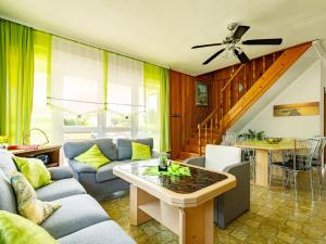 a living room with a couch and a table at Holiday Home Sunny Day by Interhome in Balatonmáriafürdő