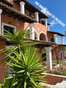 an apartment building with a plant in front of it at Villa Corfiota Moraitika Beach in Moraitika