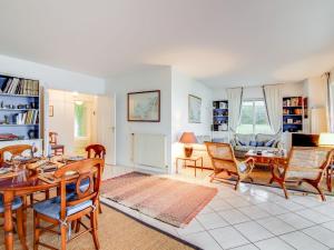 a living room with a table and chairs at Apartment La Baie by Interhome in Dinard
