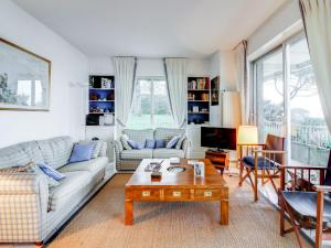 a living room with a couch and a coffee table at Apartment La Baie by Interhome in Dinard