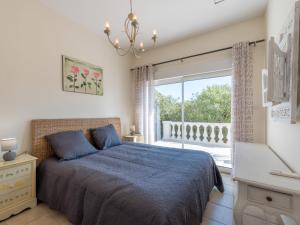 a bedroom with a bed and a large window at Villa Clos des collines by Interhome in Gassin