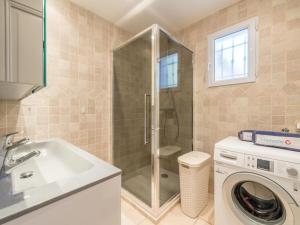 a bathroom with a shower and a washing machine at Villa Clos des collines by Interhome in Gassin