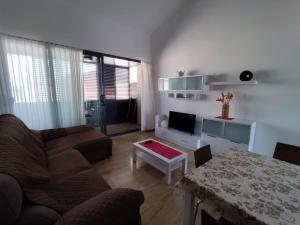 a living room with a couch and a table at Apartamento Numi II in L'Ametlla de Mar