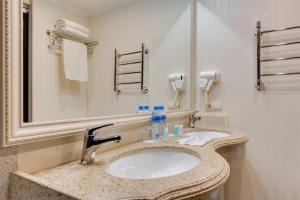 a bathroom with a sink and a mirror at Le Sart Resort in Vnukovo