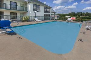 a large swimming pool with a ramp in front of a house at Days Inn by Wyndham Sanford in Sanford