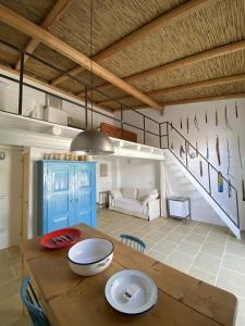 a living room with a wooden table and a couch at Galeta Masseria in Nardò