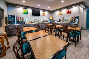 Quality Inn & Suites في دانفيل: مطعم بطاولات وكراسي وبار