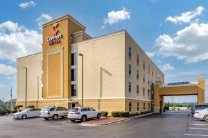 a building with cars parked in a parking lot at Comfort Suites Anderson-Clemson in Anderson