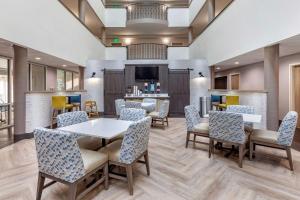 a waiting room at a hospital with tables and chairs at Comfort Suites Anderson-Clemson in Anderson
