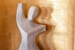 a sculpture of a white chair on a wall at Zahara Beach & Spa by QHotels - Adults Recommended in Zahara de los Atunes