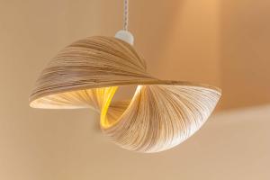 a hanging light with a wicker shade on a ceiling at Zahara Beach & Spa by QHotels - Adults Recommended in Zahara de los Atunes