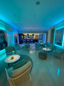 a living room with couches and tables and blue lights at Hotel Miramare & Spa in Sestri Levante