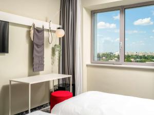 a hotel room with a bed and a window at ibis Bucharest Politehnica in Bucharest