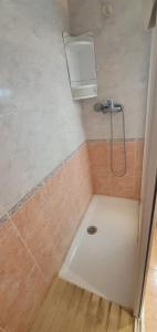 a shower in a bathroom with a sink and a shower head at COBLANCA 20 - Fincas Arena in Benidorm