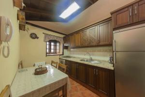 a kitchen with a sink and a refrigerator at Casa Rural Monte del Agua in Los Silos