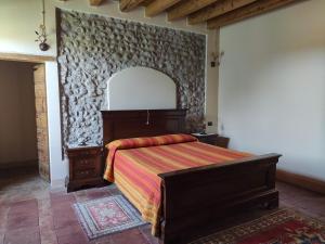 a bedroom with a bed and a wall at B&B Santa Cristina in Montichiari