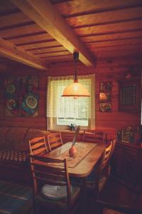 d'une salle à manger avec une table, des chaises et une fenêtre. dans l'établissement Namelis Rudnios kaime “Nykštukas”, à Rudnia