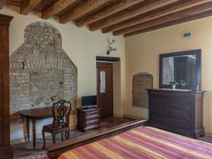 a bedroom with a bed and a desk and a table at B&B Santa Cristina in Montichiari