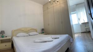 um quarto com uma cama branca com duas almofadas em Appartments near 7 km 5001155 em Odessa