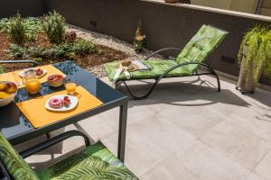 a patio with a table and a chair with food on it at FREE parking Marli 4 - Room with private entrance - in Dubrovnik