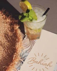 a drink with a lemon and a straw on a table at Helios Benidorm in Benidorm