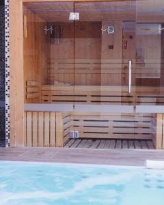 a row of wooden benches in a swimming pool at Helios Benidorm in Benidorm