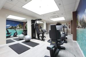 a gym with treadmills and exercise equipment in a room at Helios Benidorm in Benidorm