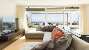 a living room with a couch and a large window at Vista Atlántico in Aguatona