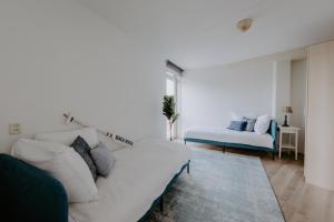 Voodi või voodid majutusasutuse Stijlvol appartement op strand Makkum toas