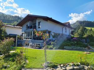 a house with a garden in front of it at Apartment Familie Grünauer in Sankt Johann im Pongau