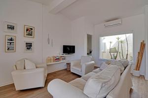 a white living room with white furniture and a window at Vilamoura Golf Villa 1 by Homing in Vilamoura