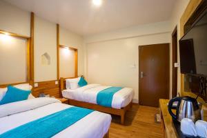 Tempat tidur dalam kamar di Hotel Himalayan Glacier