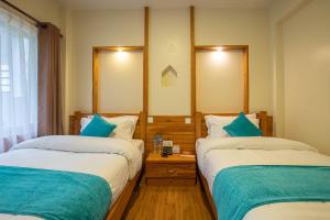 Tempat tidur dalam kamar di Hotel Himalayan Glacier