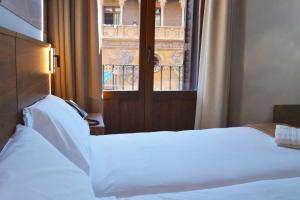 A bed or beds in a room at Encanto Tarazona