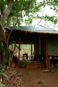 a house with a green roof with a picnic table at Khaama Kethna Eco Sustainable Village in Agonda